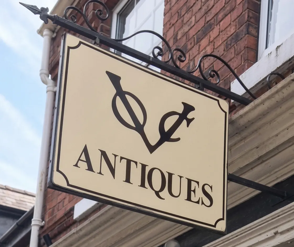The VOC Antiques hanging sign on Witham Road